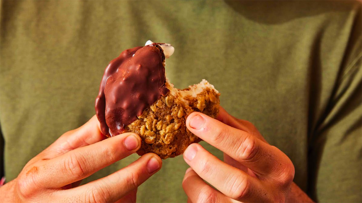 Ice cream cookie sandwich dipped in chocolate.